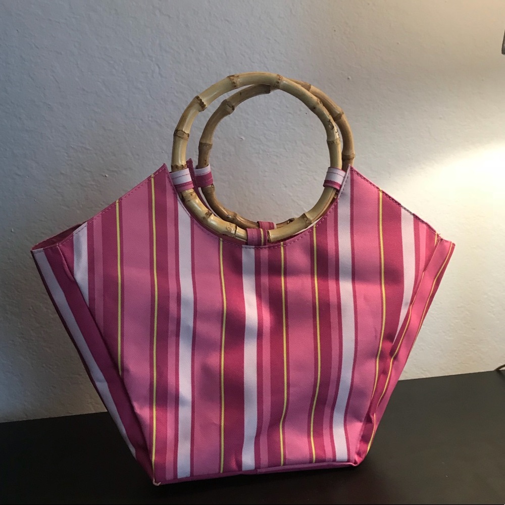 Pink striped handbag with bamboo handle.